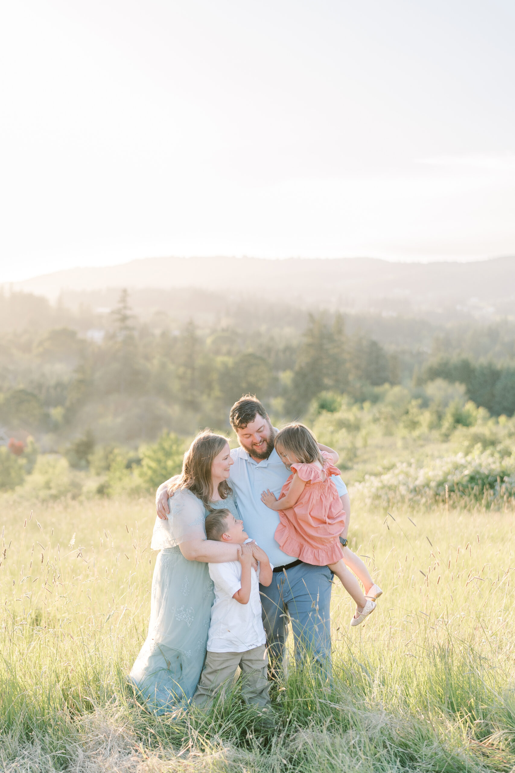 family of four stands in the rolling hills of Oregon's wine country near Portland Oregon by photographers in McMinnville Oregon Samantha Shannon