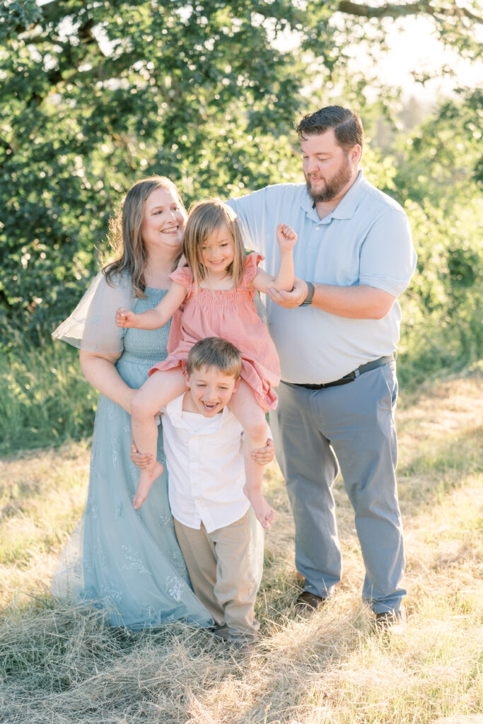 family of four with sister on brother's shoulders in Oregon's wine country near McMinnville Oregon